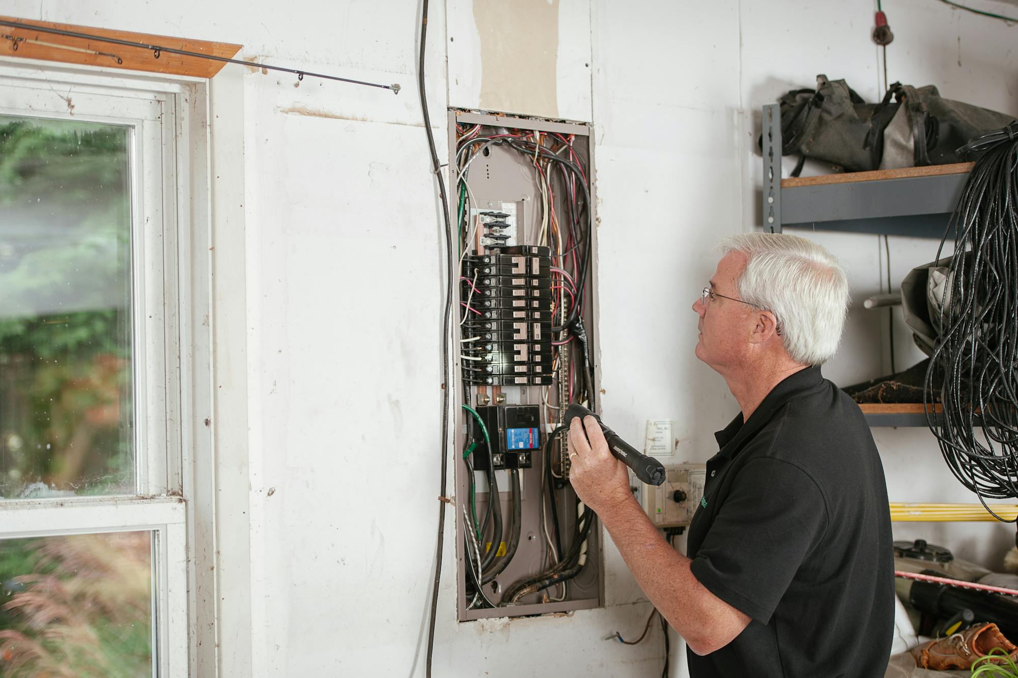 Electrician carrying out an EICR inspection on a consumer unit