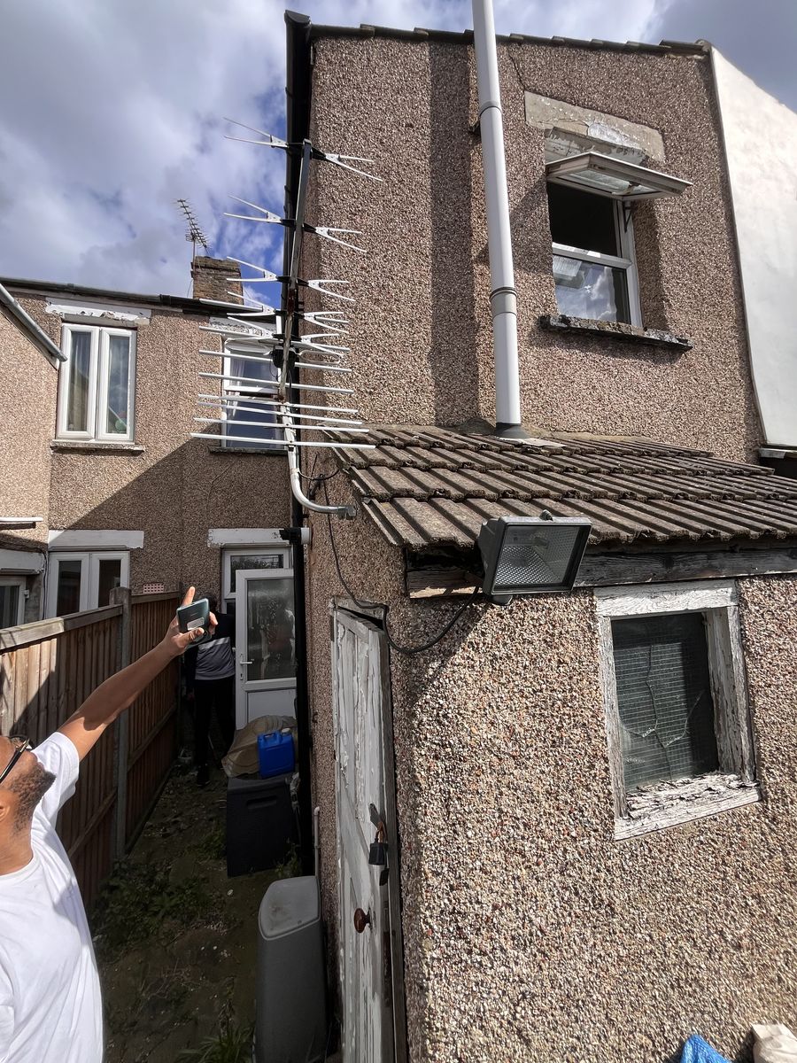 EPC assessor inspecting rear of terraced property